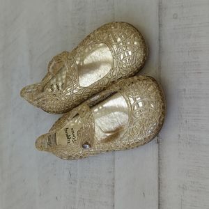 Unused gold baby shoes